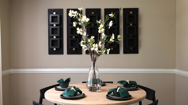 Dining area with crown molding and chair rail