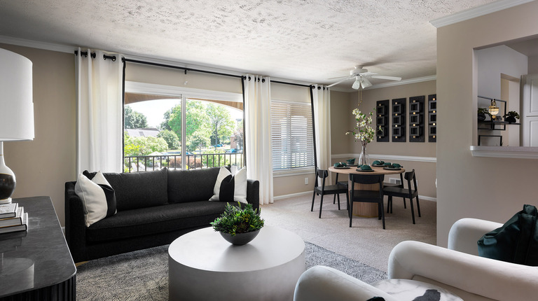 Open living room with bright windows and balcony
